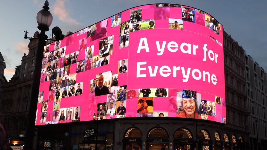 An image of the Piccadilly screen with many images of people on a pink background with text reading
