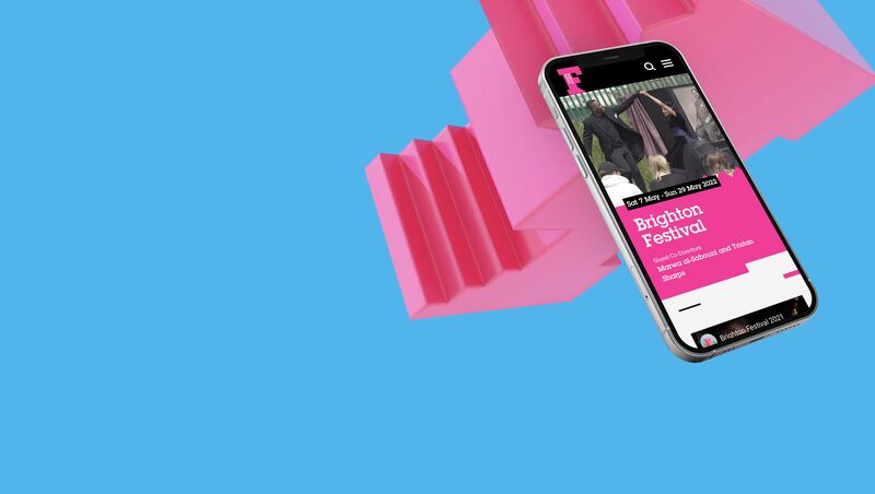 A phone shows the website, overlayed over a 3d, pink Brighton Festival logo, on a blue background