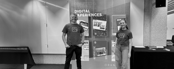 A black and white image of a few members of the Grandad team at a conference
