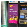 A Welcome to Wandsworth poster next to a ticket purchase machine in the underground