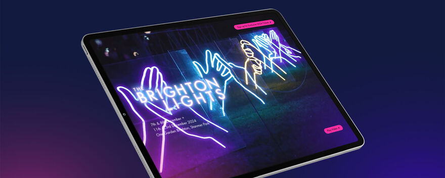 A iPad showing  the Brighton Lights website showing an image of some ligts with 