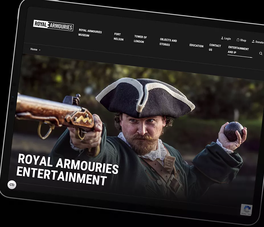 A tablet shows the Royal Armouries website with a large image of their work on the website  