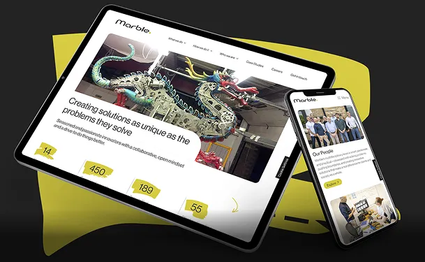 On a dark grey background with a green/yellow pen mark on it, a tablet and a phone show the Marble website