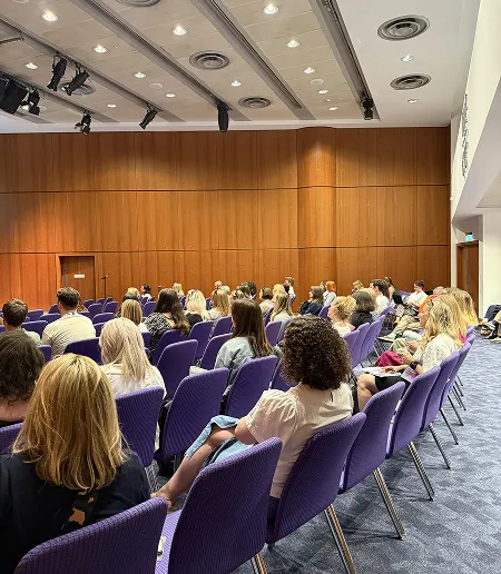 The audience at a conference watching a talk by Grandad.  